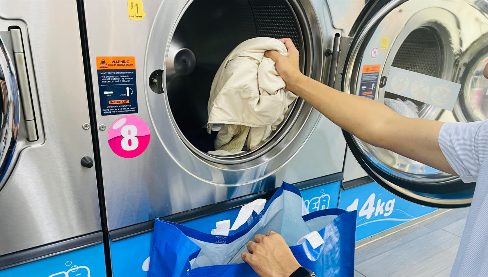 Cleanpro customer collecting their laundry from Dexter washer