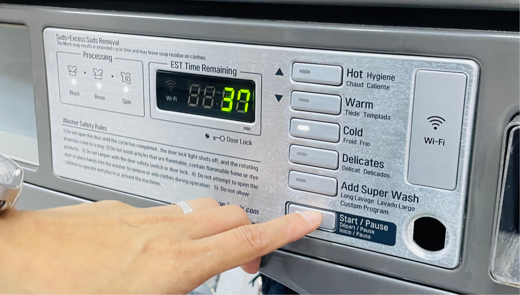 Cleanpro customer pressing the start button on LG washer